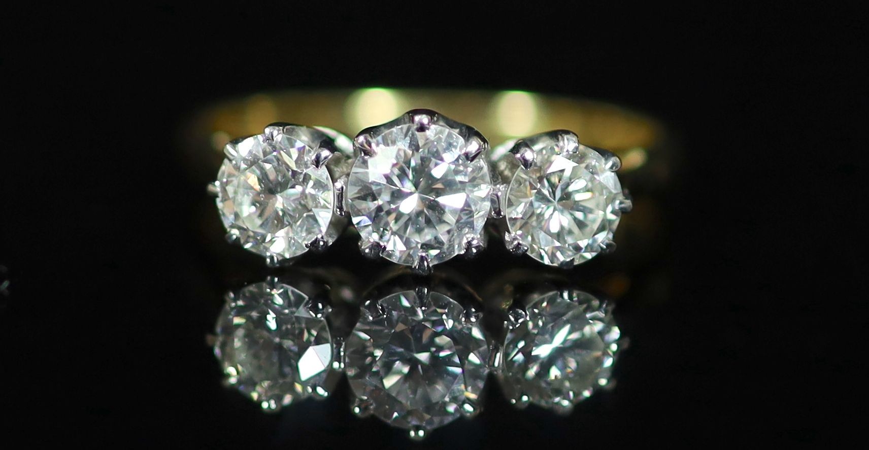 A 18ct gold and platinum, three stone diamond ring